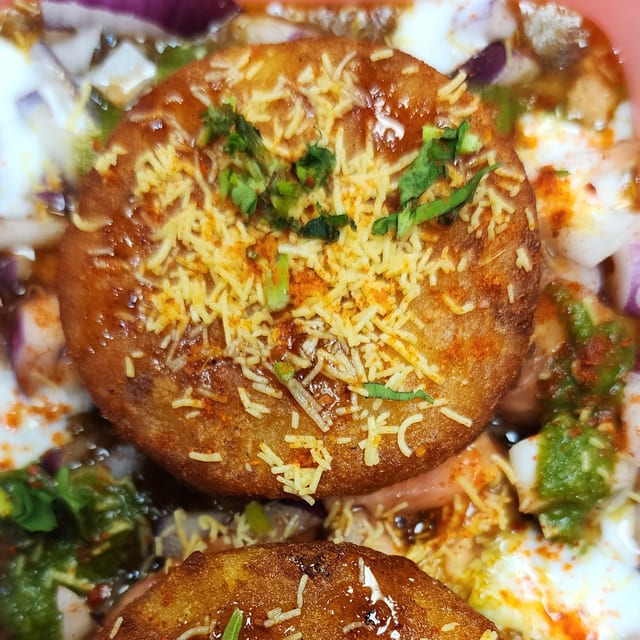Samosa Chaat or Aloo Tikki Chaat.